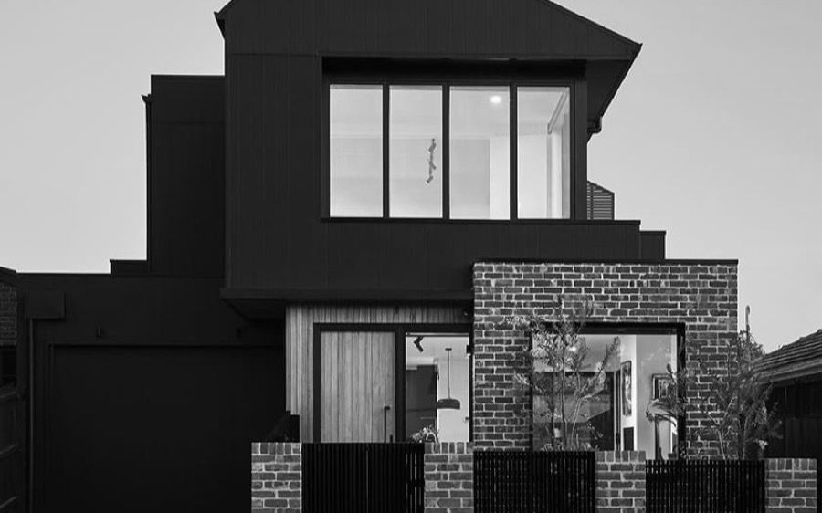 Modern two storey townhouse with black cladding and brick frontage